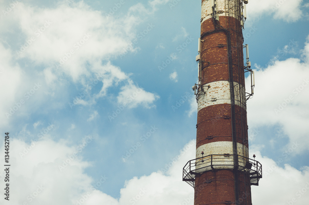 brick chimney with equipment for cellular communication on a sky background brick chimney with equipment for cellular communication on a sky background