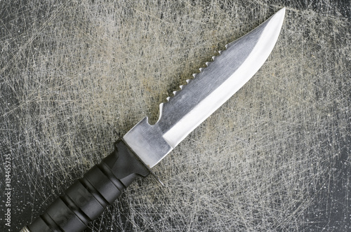 Survival Knife Closeup On Scratched Background