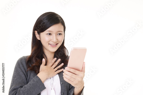スマートフォンを持つ笑顔の女性