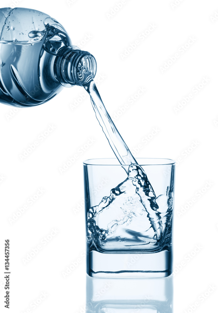 Water pouring from bottle into glass Water pouring from bottle into glass