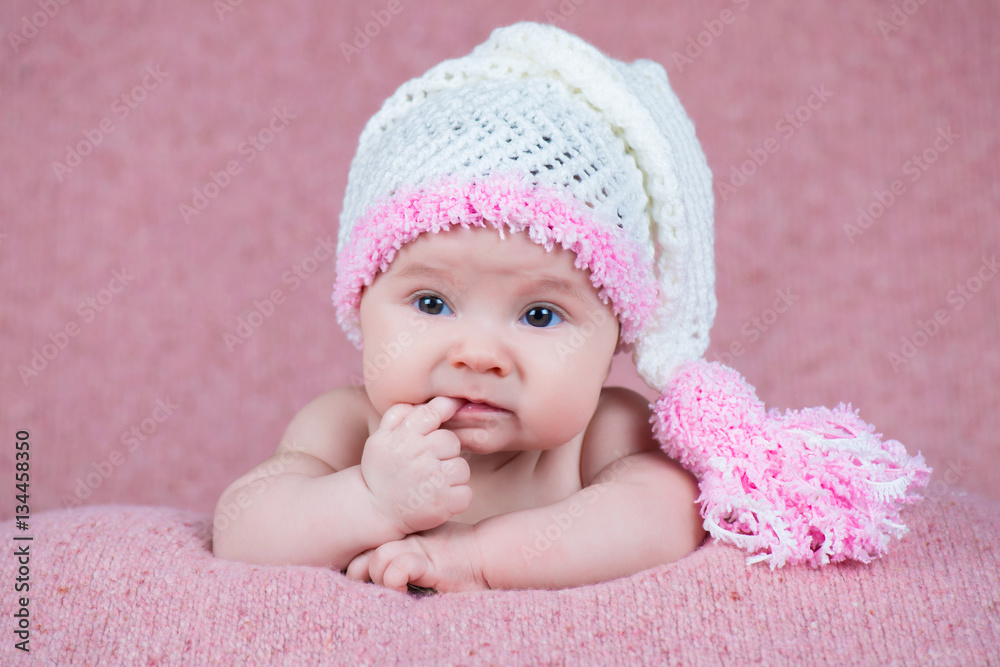 Beautiful little girl in pink warm headphones Beautiful little girl in pink warm headphones