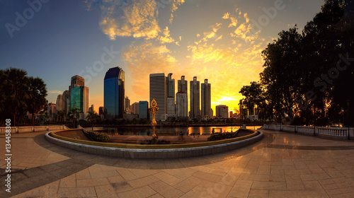 Business district cityscape from a park with sunrise time from B