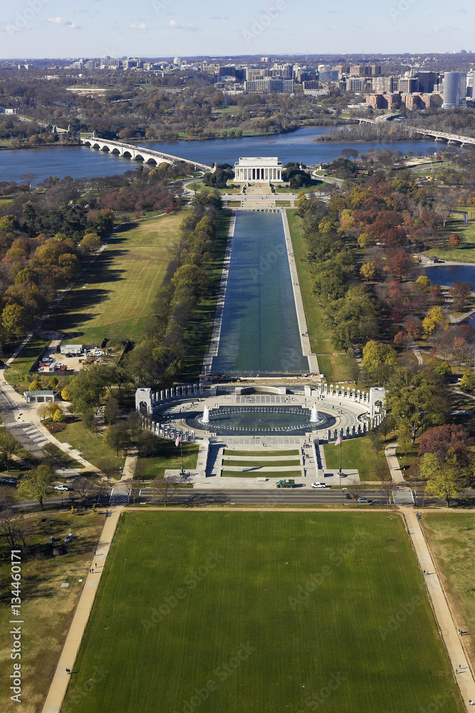 Grand aerial view looking westwards along the ceremonial boulevard of the National Mall in Washington DC including historic sights, the Lincoln Memorial, Reflecting Pool & National WWII Memorial
