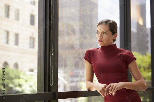 Young white businesswoman looking out of office window Free Download Young white businesswoman looking out of office window - GFXLoad