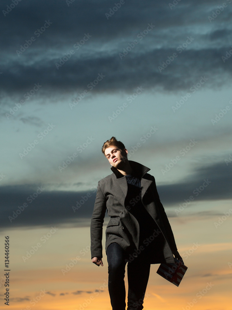 Handsome man in dusk with present Handsome man in dusk with present
