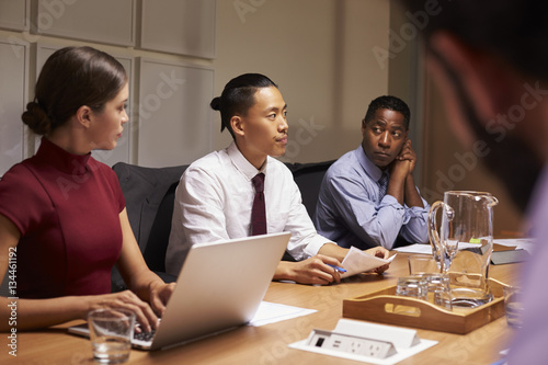 Corporate business colleagues at evening meeting, close up