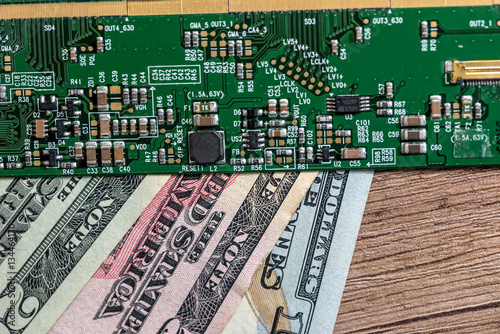 dollar bills from technology. green motherboard. close up.