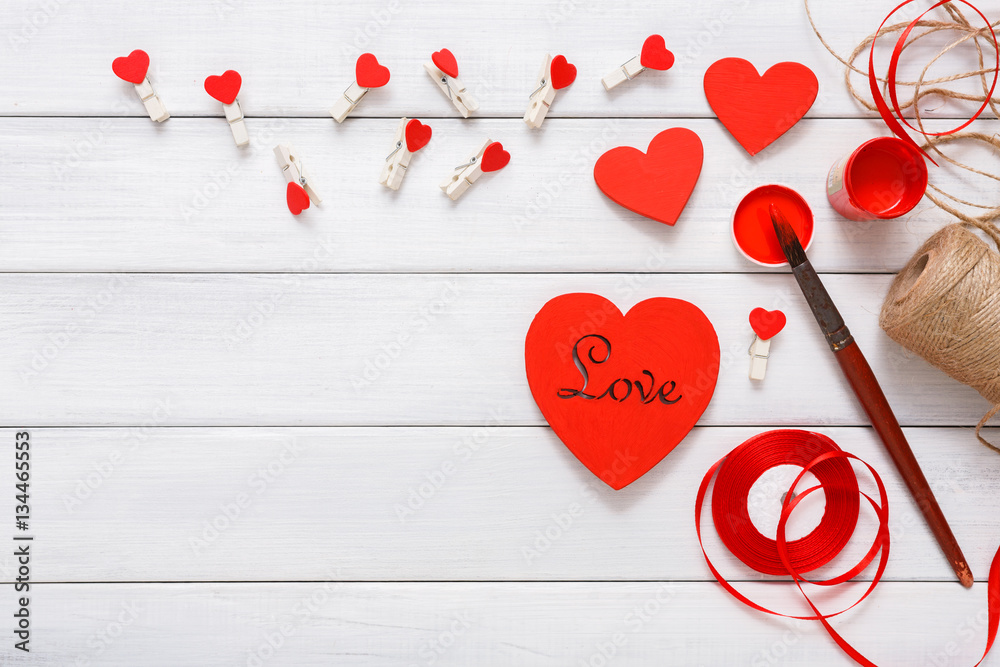 Fototapeta premium Valentine day diy handmade hearts making, top view on wood