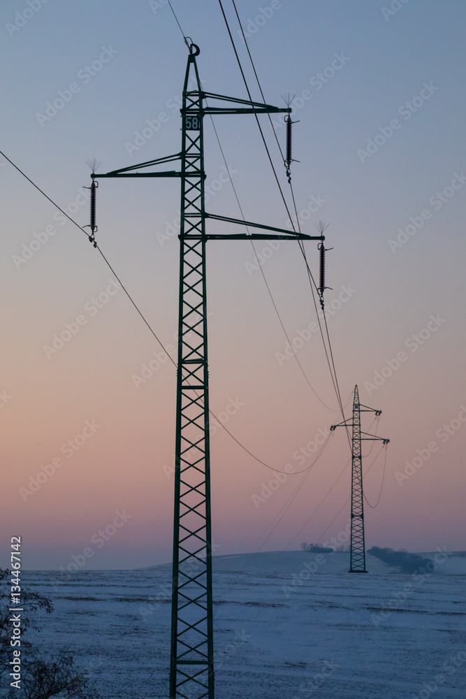 high- voltage power transmission winter evening