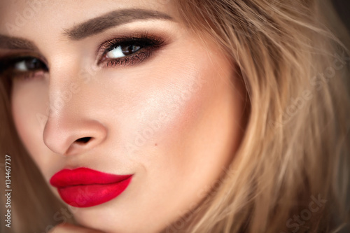 Beautiful blonde model with red lips. Close up portrait
