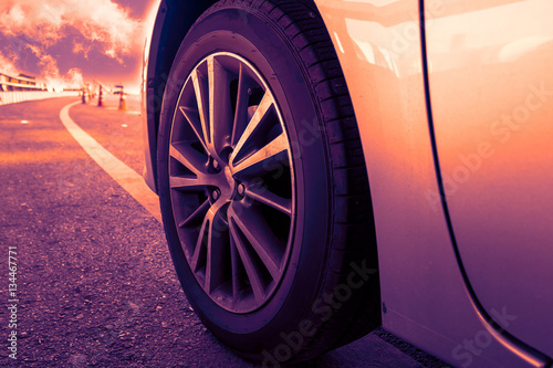 Closeup wheels of cars on the road (Sunset tone)