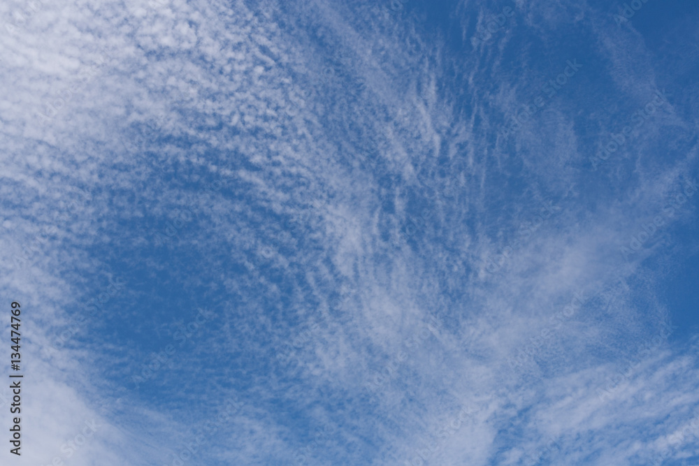 Beautiful pattern of white cirrus clouds in blue sky.