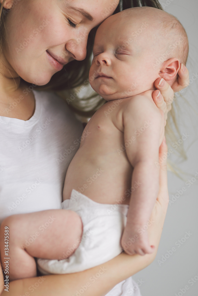Mother holding her newborn baby in the hands. Mother holding her newborn baby in the hands.