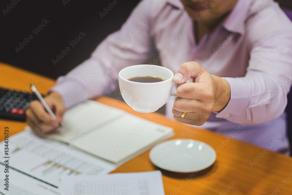 Close-up of business man holding cups of coffee Close-up of business man holding cups of coffee
