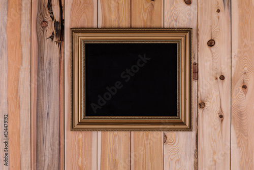 blank vintage gold frame on the old wooden background