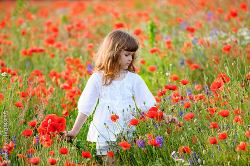 teen girl among a field of poppies