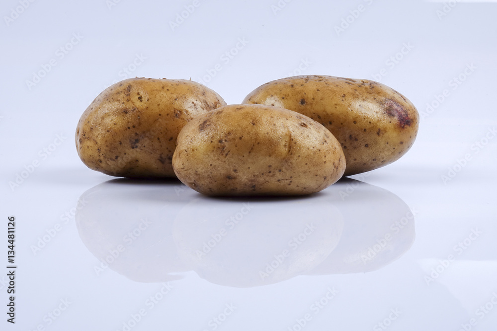 Fototapeta premium Fresh raw potato on white background.