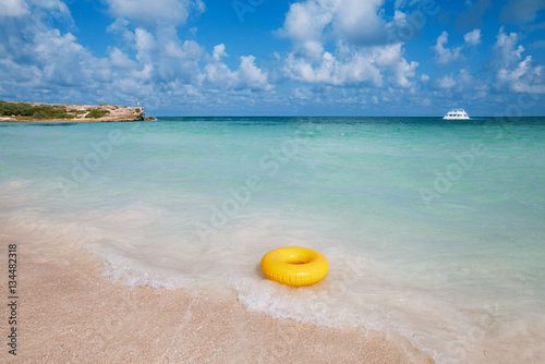 floating ring on blue clear sea and beach