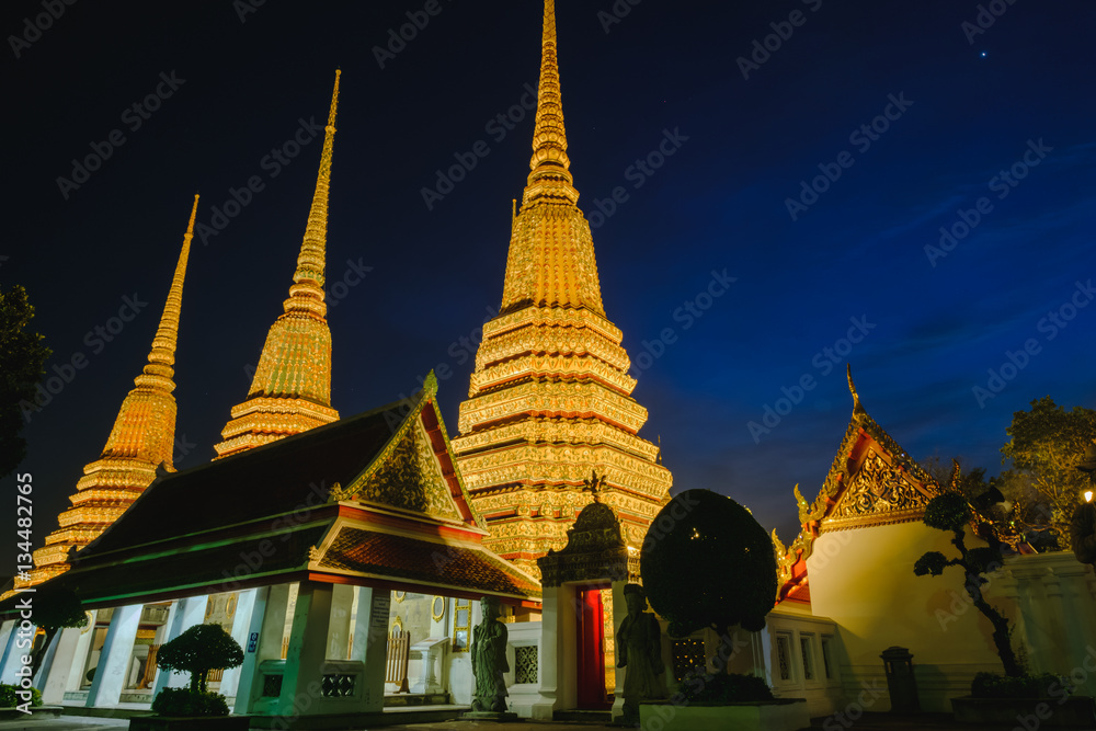 Fototapeta premium Thai Pagoda art architecture with sunset in Wat Phra Chetupon Vimolmangklararm (Wat Pho) temple, Thailand.