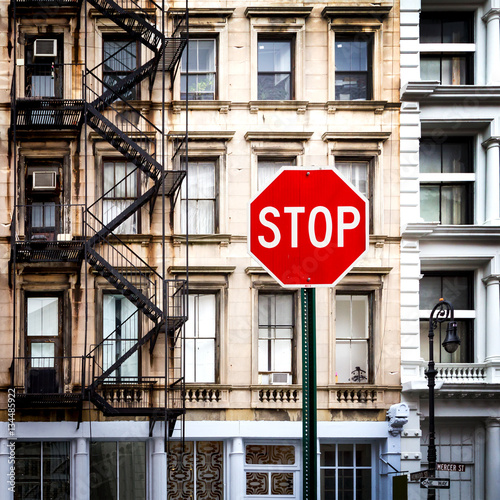 Stop sign in front of old buildings in New York City NYC photo