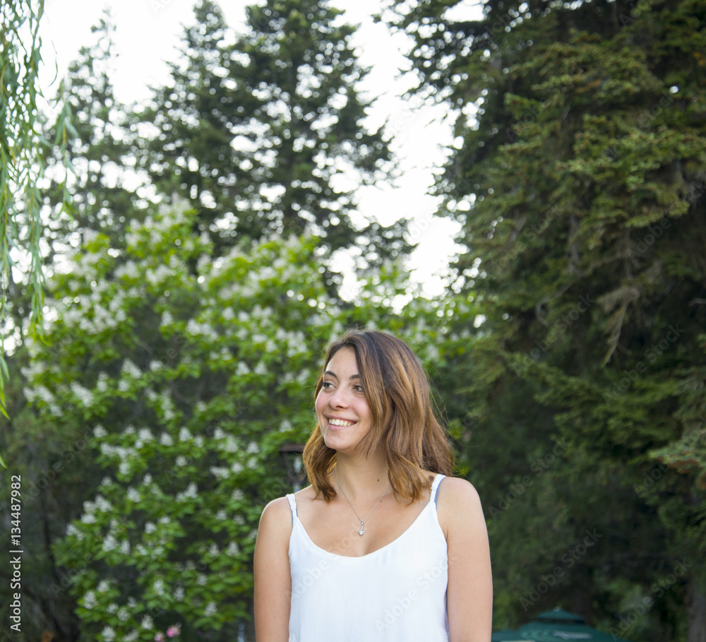 girl in white dress in the park smiling