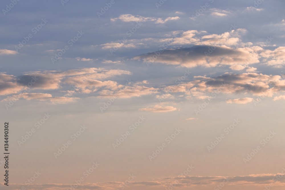 Sky with blue-gray clouds at orange sunset