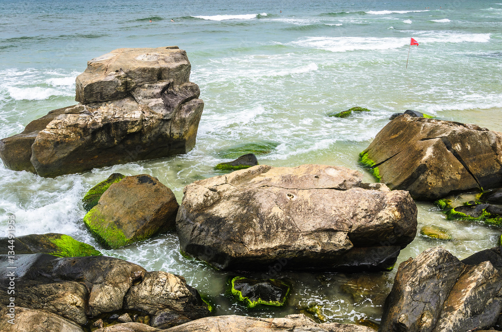 Beautiful scene with stones with green moss on the seashore Beautiful scene with stones with green moss on the seashore