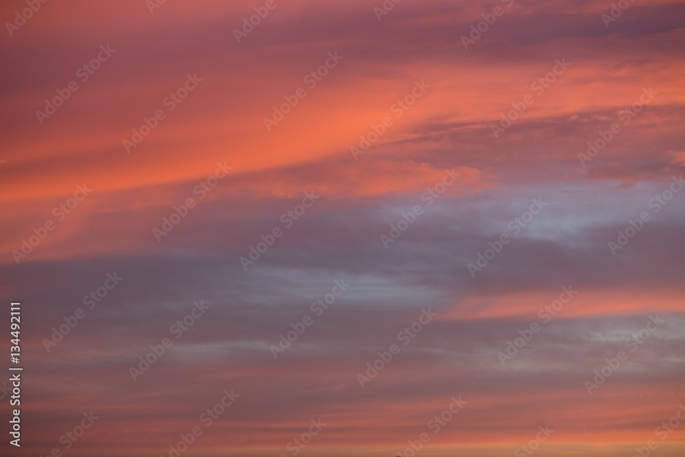 Orange and grey sky with clouds at sunset