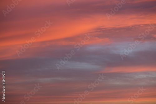 Orange and grey sky with clouds at sunset © shadowspawn