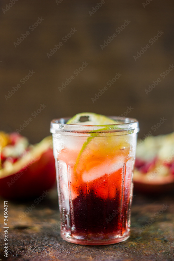 Pomegranate lemonade on black rustic metal table Pomegranate lemonade on black rustic metal table