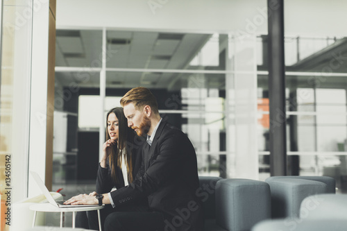 Business couple using laptop