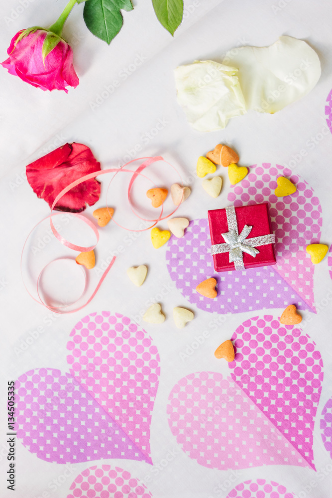 Red box gift surronded by hearts and flowers. Red box gift surronded by hearts and flowers.