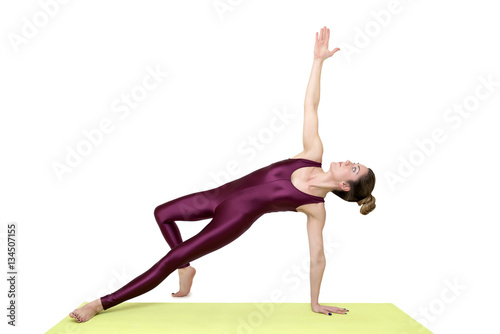 Young woman practicing yoga in the studio