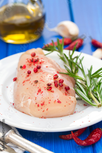 raw chicken with pink pepper and rosemary
