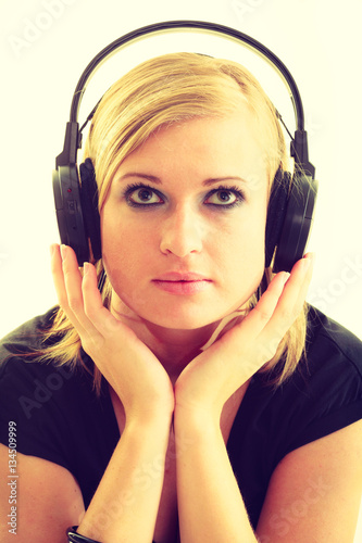 Blonde girl in big headphones.