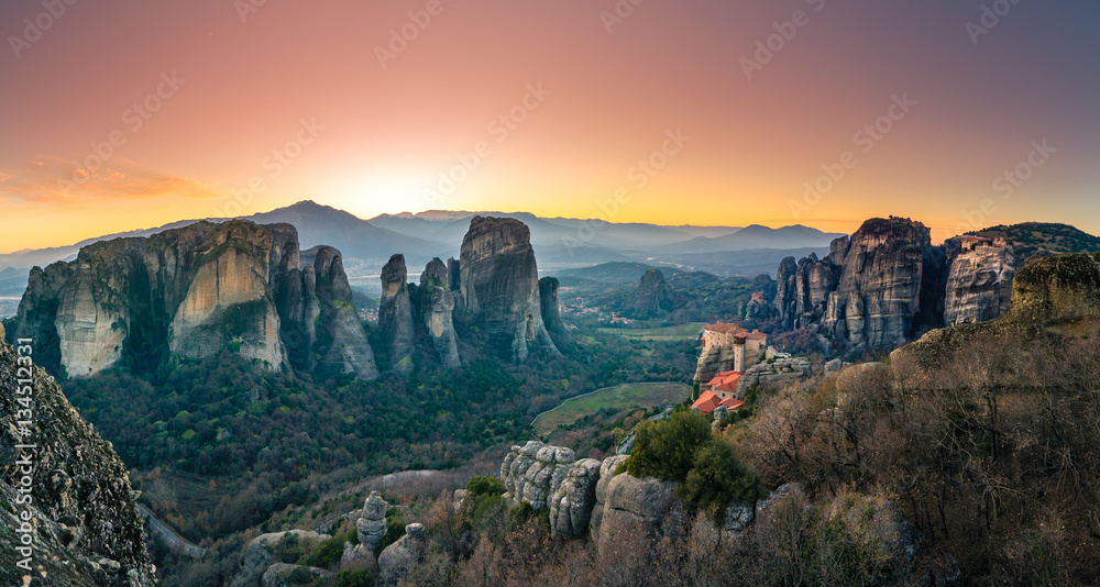 Breathtaking view of Meteora Roussanou Monastery at sunset, Greece. Geological formations of big rocks with Monasteries  on top of them.