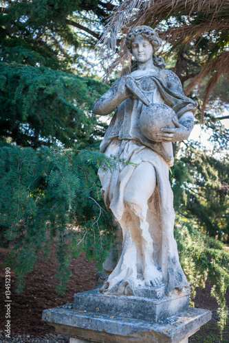 old sculpture of a woman in the park