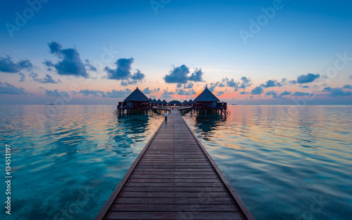 Fototapeta Naklejka Na Ścianę i Meble -  Luxus Resort in the Maldives. Grand sunset over the Indian Ocean. Evening for relaxation and enjoyment.