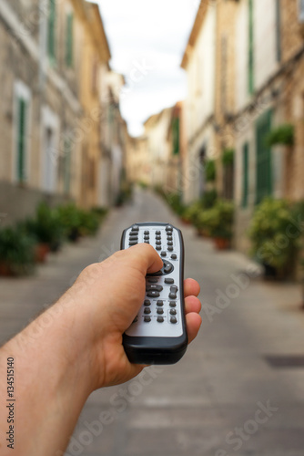Summer vacation concept. Man holding remote control.