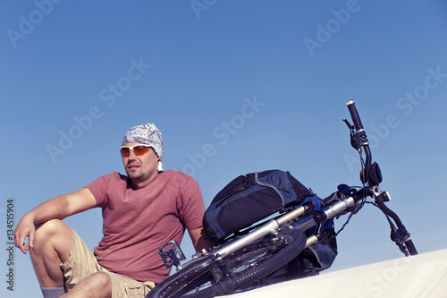 Traveling man on a bicycle in the desert.
