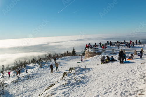 People on terrace in mountain Jested over clouds