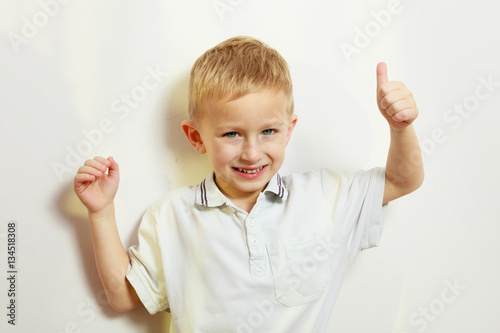 Little boy playing showing thumb up gesture