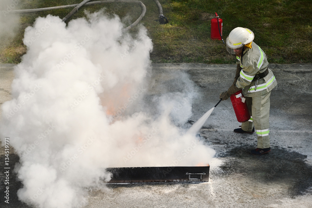 Instructor showing how to use a fire extinguisher on a training