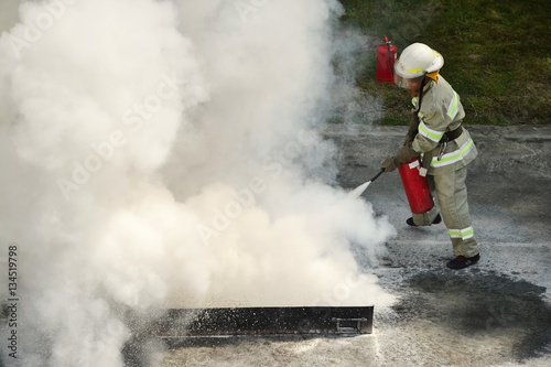 Instructor showing how to use a fire extinguisher on a training