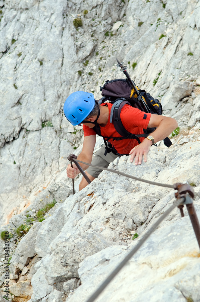 Mountaineer climbing up the steepy mountain in summer. Mountaineer climbing up the steepy mountain in summer.