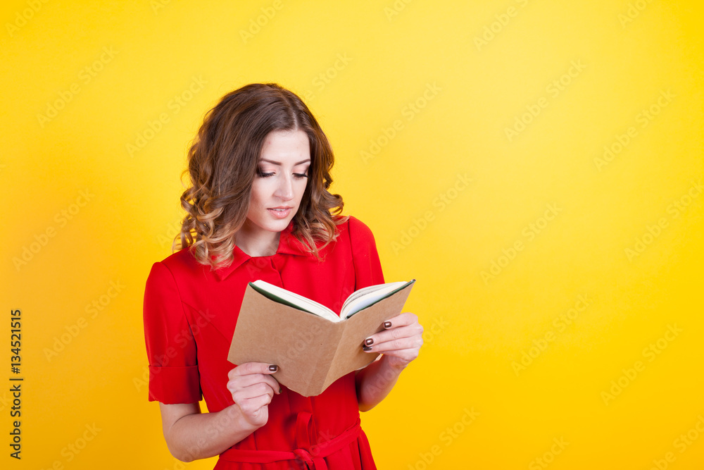 woman in red dress is holding a book woman in red dress is holding a book