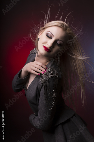 Fototapeta Naklejka Na Ścianę i Meble -  Luxurious young blonde woman with hair in motion