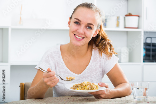 girl with chestnut hair eating porridge
