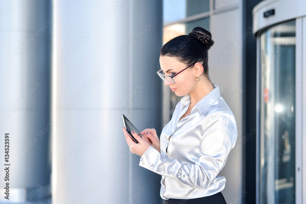 Portrait of a business woman in glasses, holding a Tablet. The concept of leadership and success. Portrait of a business woman in glasses, holding a Tablet. The concept of leadership and success.