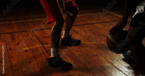 Sportsmen tackling for basketball in basketball court 4k